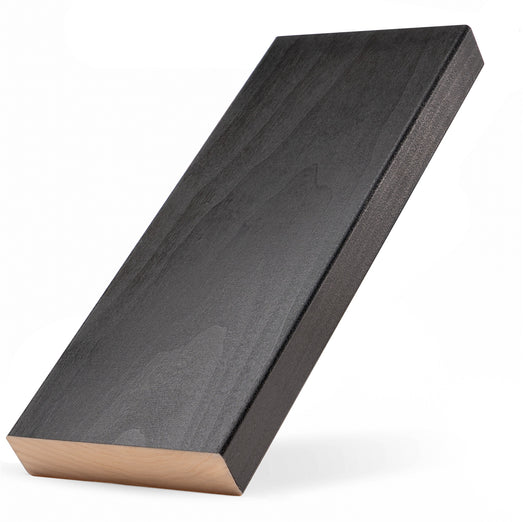 Aspen Midnight Black 2x5 bench board tilted upright, showing dark face grain, black edge and pale end grain