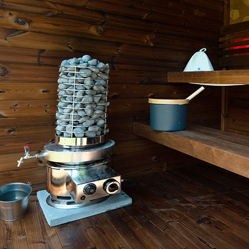 Titan SL1 gas sauna heater with the water tank installed in a wooden sauna