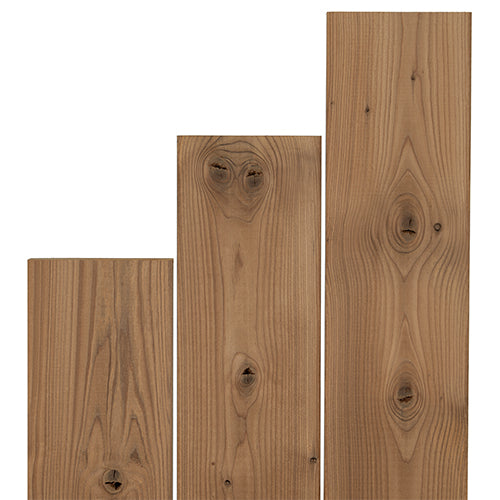 Three Thermo-Spruce 2x4 bench boards standing upright in stepped lengths, showing knots and brown face grain