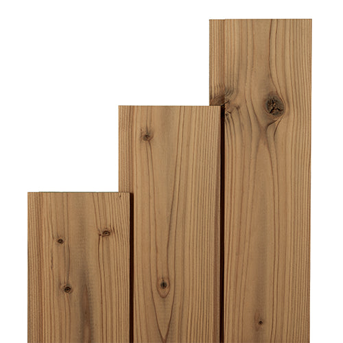 Thermo-Spruce paneling boards in three stepped lengths standing side by side, showing vertical grain and knots