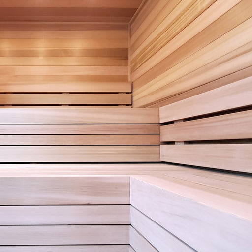 Sauna interior with horizontal wall paneling and two-tier light wood benches in a corner layout