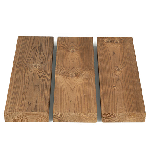 Three Thermo-Spruce 2x4 bench boards side by side, showing face grain and knots, with end grain at the bottom