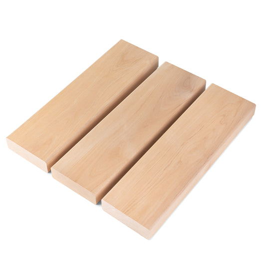 Three Alder 2x4 bench boards side by side at an angle, showing pale face grain and square ends