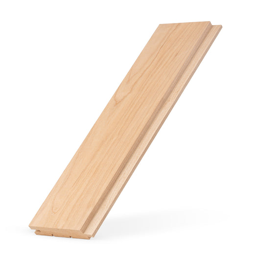 Alder 1x4 tongue-and-groove paneling board propped at an angle, showing face grain and the tongue edge