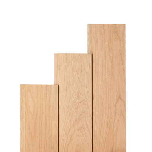 Three alder paneling boards of different lengths standing in a stepped arrangement, showing light face grain