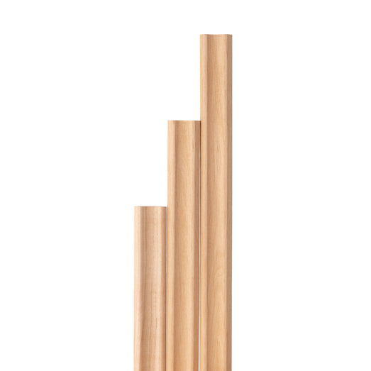 Alder 1x2 Inside Corner Trim pieces of three different lengths stood upright in a stepped row, showing light grain
