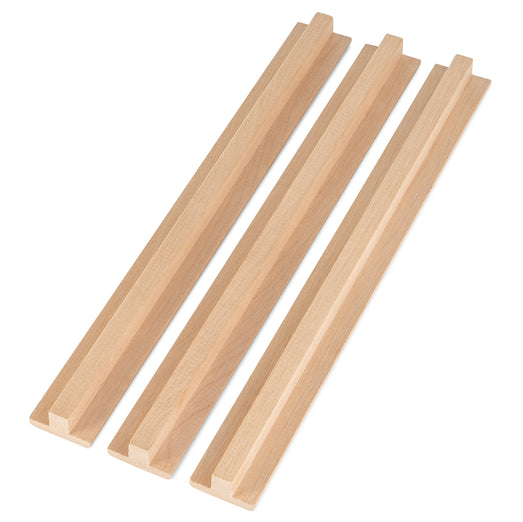 Alder 1x2 T-Molding, three pieces side by side at an angle, showing the raised center rib and flat flange of each