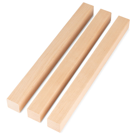 Three Alder 2x2 Trim pieces lying side by side at the same length, showing light face grain
