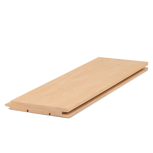 Alder 1x5 tongue-and-groove paneling board at an angle, showing smooth face grain and grooved bottom edge