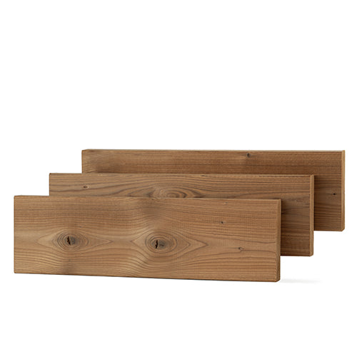 Three Thermo-Spruce 2x4 bench boards staggered in a row, face grain with knots and tight swirled grain visible