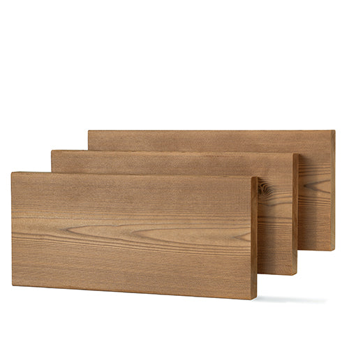 Three Thermo-Spruce 2x6 bench boards staggered front to back, showing brown face grain and a knot on the rear board