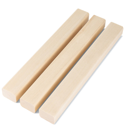 Three Aspen 2x2 Trim pieces lying side by side on a white background, with smooth pale grain along their faces