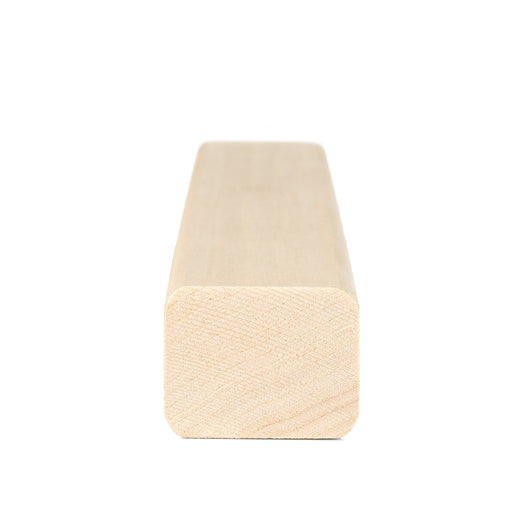 Aspen 2x2 Trim piece end view showing the rounded corners and fine end grain pattern, with the board extending back