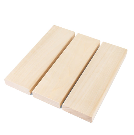 Three Aspen 2x4 bench boards side by side, showing the smooth pale faces