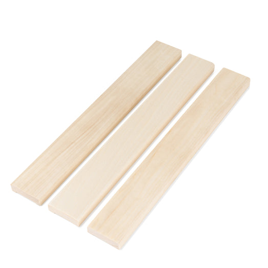 Three Aspen 1x2 Door Trim boards side by side, showing the pale smooth face grain on a white background