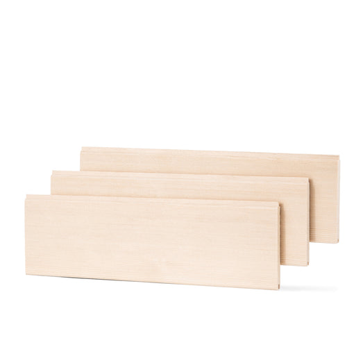 Three Hemlock 1/2x4 tongue-and-groove paneling boards standing apart in a staggered row, with pale face grain visible