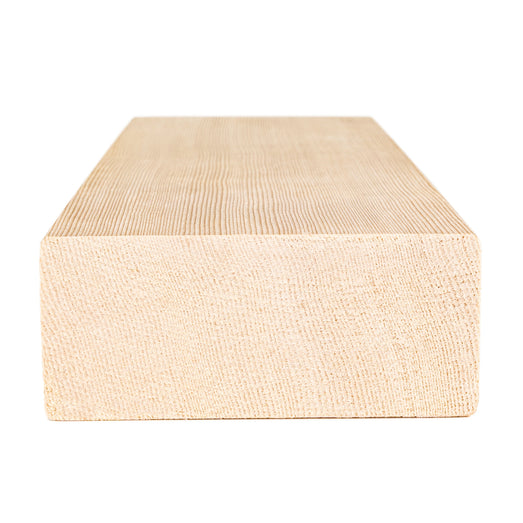 Hemlock 2x4 bench board end view showing the cut end grain and fine growth rings along the top face