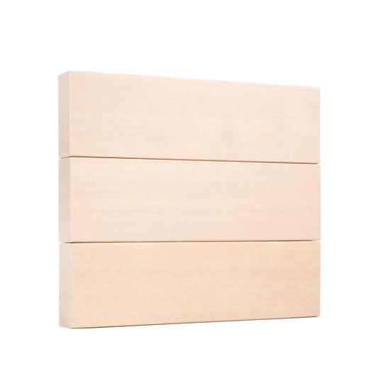 Three Hemlock 2x4 bench boards stacked flat in a neat pile, showing smooth clear faces