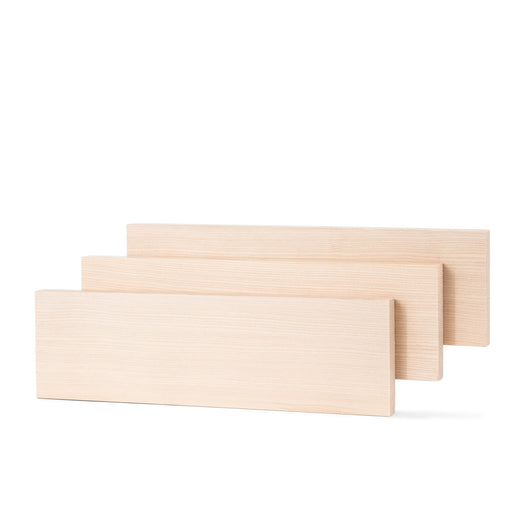 Three Hemlock 1x4 bench boards standing on edge and staggered front to back, showing face grain