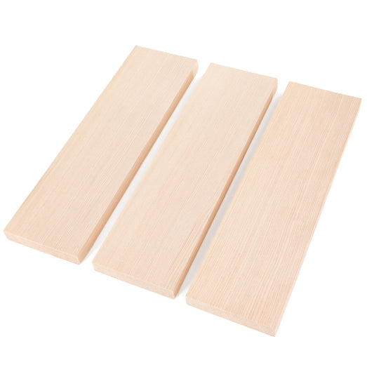 Three Hemlock 1x4 bench boards laid side by side at an angle, showing fine vertical face grain