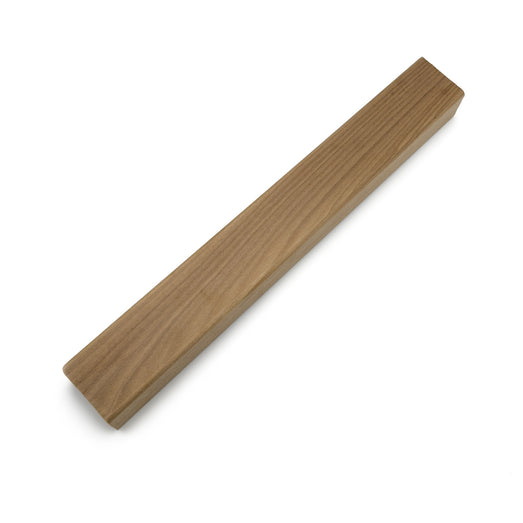 Thermo-Aspen 2x2 Trim piece laid diagonally, showing the long face grain and one squared end