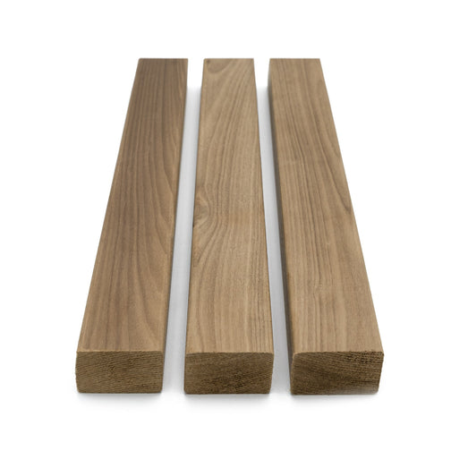 Thermo-Aspen 2x2 Trim, three boards standing side by side in a row, showing face grain and cut ends