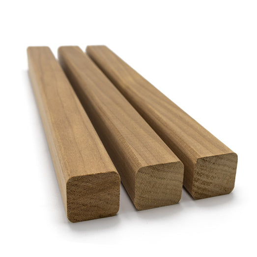 Three Thermo-Aspen 2x2 Trim pieces lying side by side, showing their square ends and long face grain