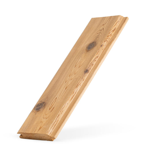 Western Red Cedar tongue-and-groove paneling board leaning upright, angled view with knots and the grooved end