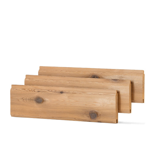 Three Western Red Cedar paneling boards stacked in a staggered row, showing face grain and knots