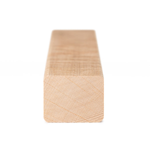 Alder 2x2 Trim piece end view showing the rectangular cross-section with fine growth lines and rounded corners
