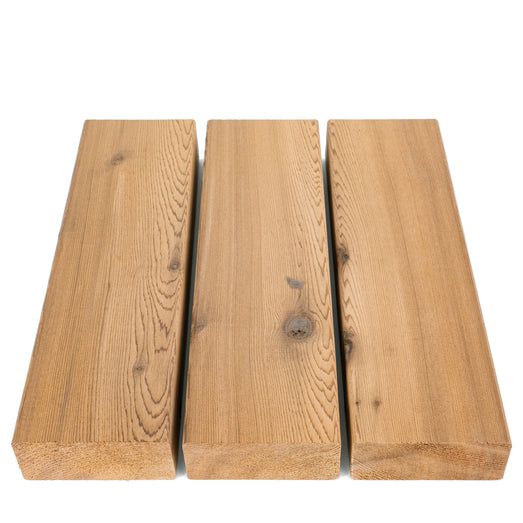 Three Western Red Cedar 2x4 bench boards in parallel, top-down view of face grain, end grain and knots