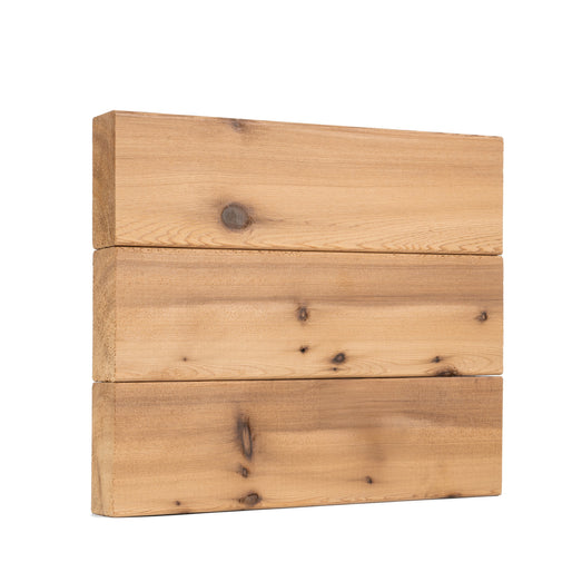 Western Red Cedar 2x4 bench boards stacked three high, showing the face grain with dark tight knots