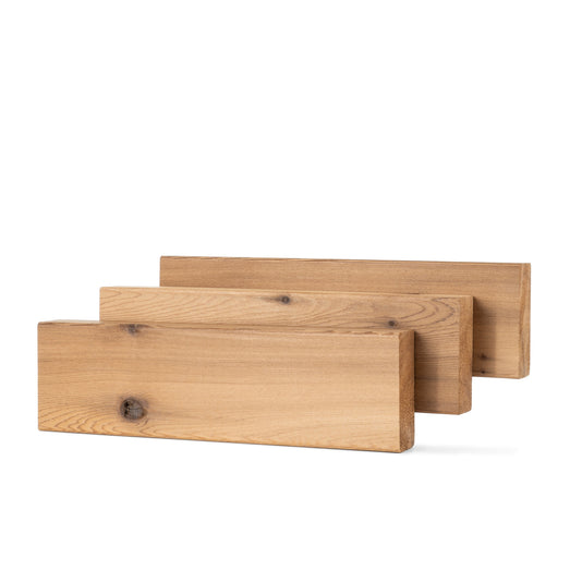 Three Western Red Cedar 2x4 bench boards staggered in a row, showing the wide face and a dark knot