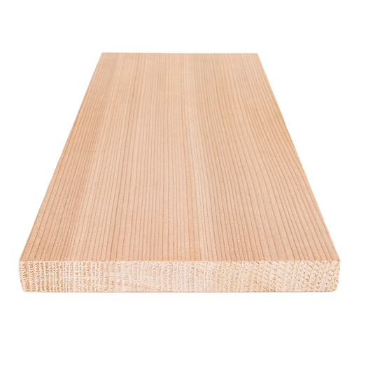Western Red Cedar 1x6 bench board angled close-up, with fine vertical face grain and a visible end-grain cross-section
