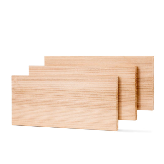 Western Red Cedar 1x6 bench boards, three standing upright and staggered, showing face grain and long edges