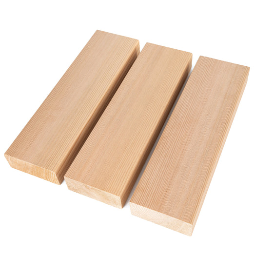 Three Western Red Cedar 2x4 bench boards laid at angles from above, showing face grain and cut ends