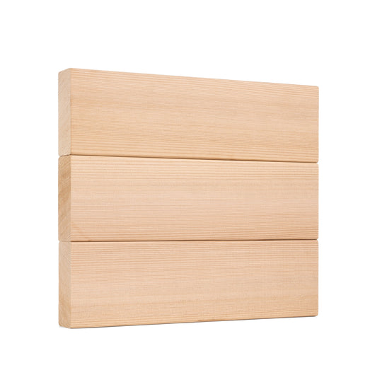Three Western Red Cedar 2x4 bench boards stacked flat, showing the smooth face grain of each board