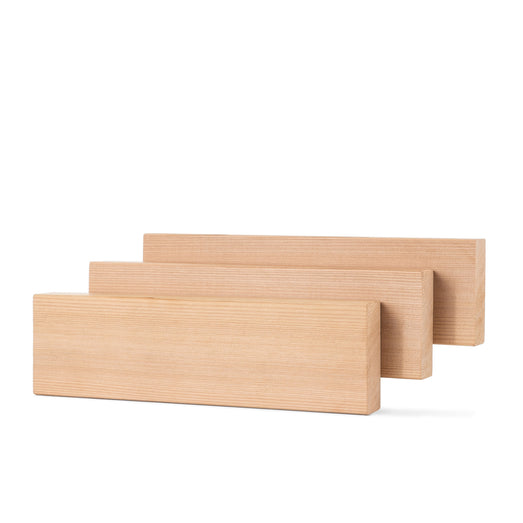 Three Western Red Cedar 2x4 bench boards standing on edge in staggered rows, showing the narrow face and grain