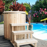 Baltic cold plunge tub with cedar steps set up poolside in a garden