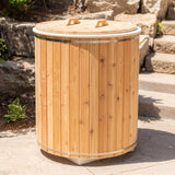 Baltic cold plunge tub closed with cedar lid on stone patio in sunlight