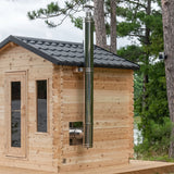 Dundalk chimney and heat shield set running up a cedar cabin sauna side wall