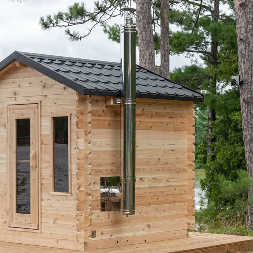 Dundalk chimney and heat shield set running up a cedar cabin sauna side wall