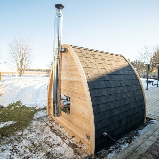Dundalk side wall chimney on a cedar pod sauna in a snowy lakeside yard