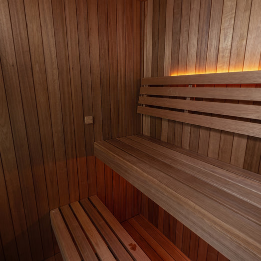 Dundalk Loft sauna interior with bench, water bucket and electric heater