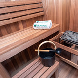 Dundalk Nook sauna interior with bench, water bucket and electric heater