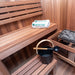 Dundalk Nook sauna interior with bench, water bucket and electric heater