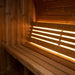 SaunaLife E8 barrel sauna cedar backrest glowing with warm LED accent lighting