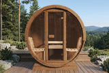 SaunaLife E8 barrel sauna installed on a deck against mountain forest backdrop