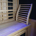 Finnmark cedar backrest resting on a sauna bench beside infrared heater panels