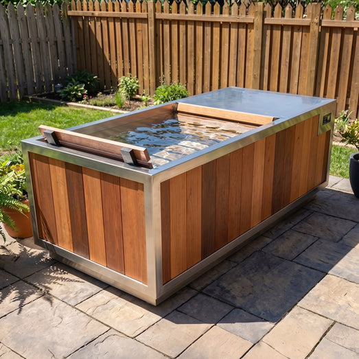 Finnmark SoulCold cold plunge tub filled with water on a backyard stone patio